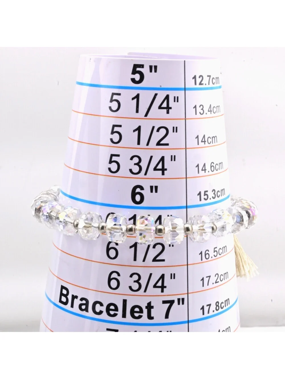 FACETED CRYSTAL STRETCH BRACELET WITH TASSLE